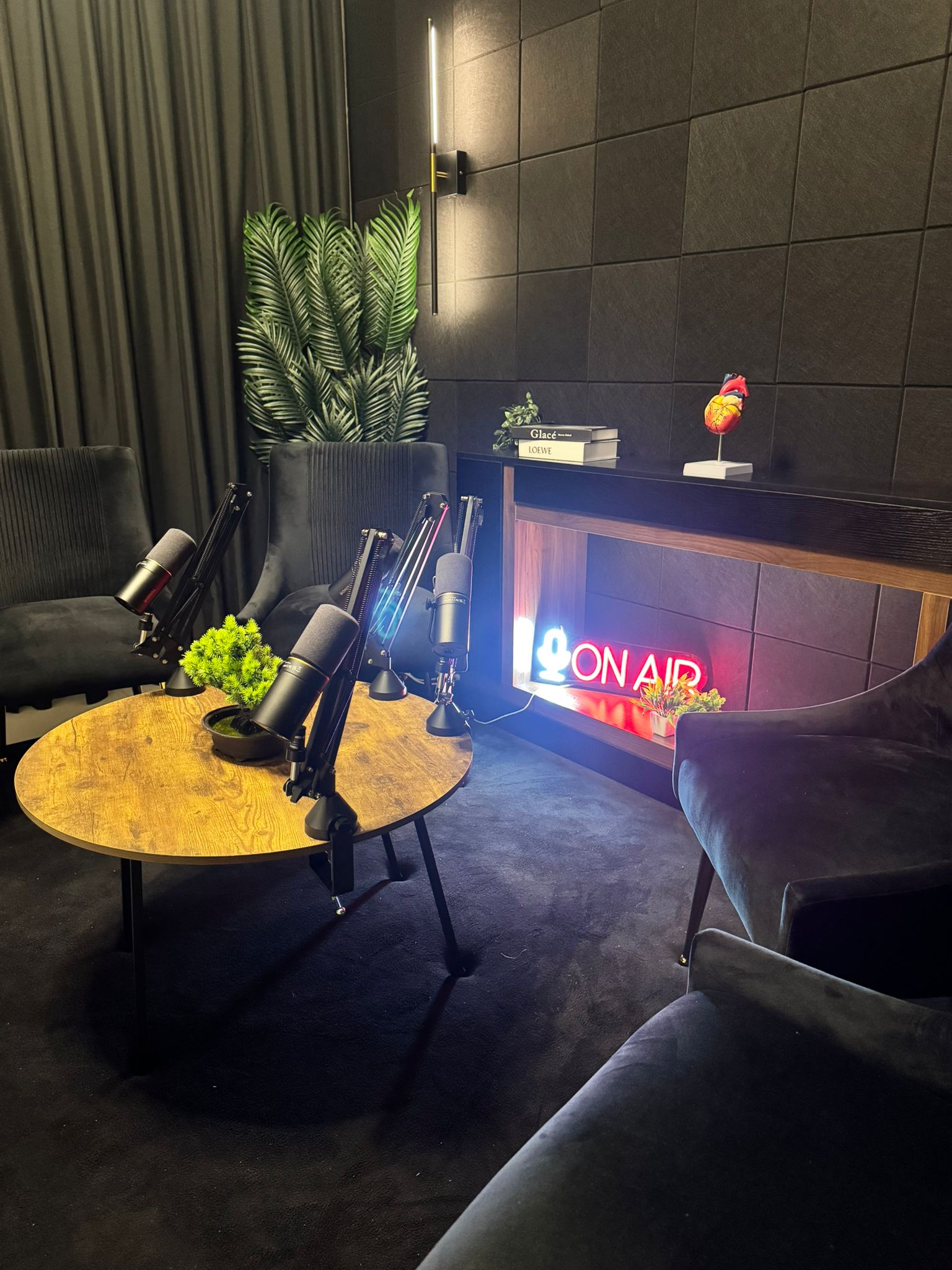 Studio 309 — podcast studio in Dubai Sports City with ON AIR neon, pro mics and velvet seating