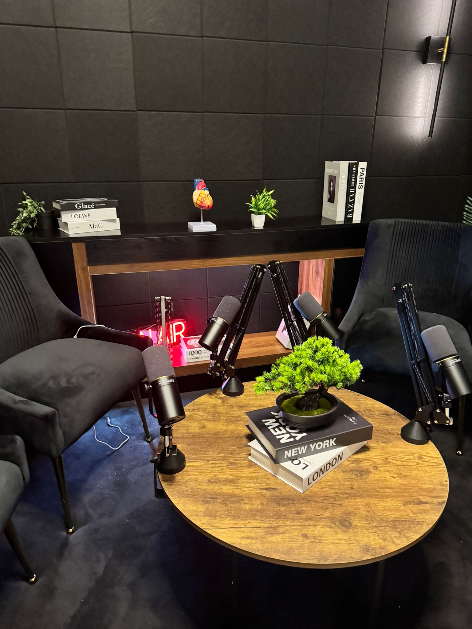 Inside Studio 309, a self-service podcast studio in Dubai with mics and a styled set