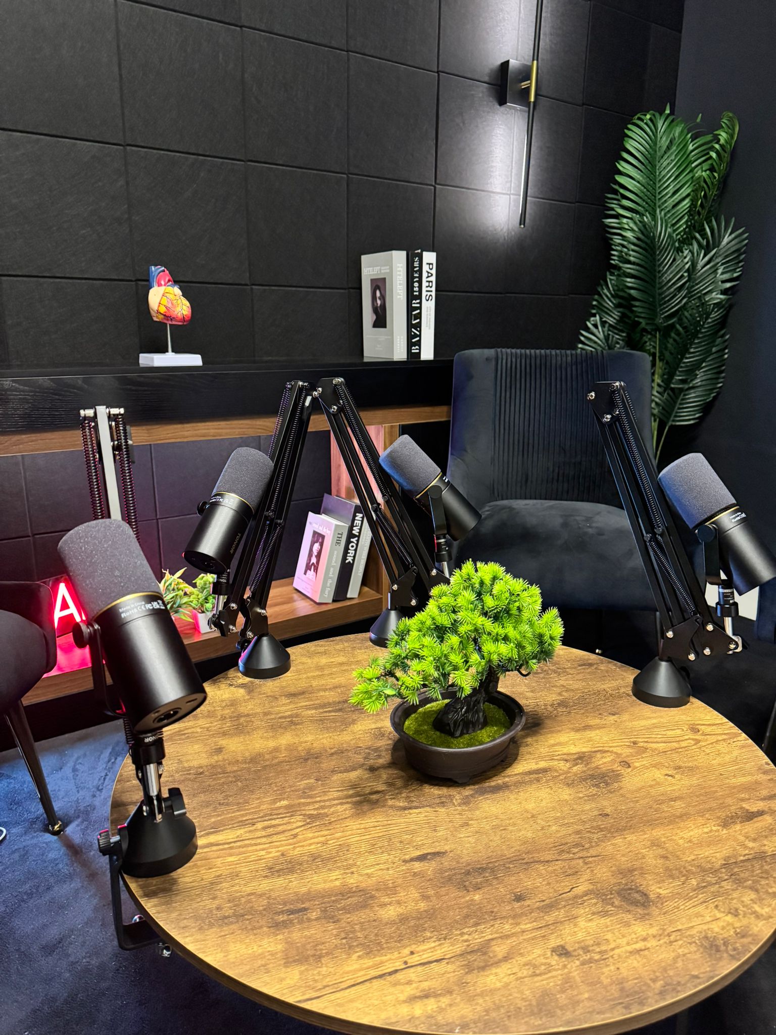 Podcast recording table with three mics on boom arms at Studio 309 Dubai
